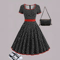 Women's multicolour polka dot pleated dress with a square collar, short sleeves, and a front zip fastener.