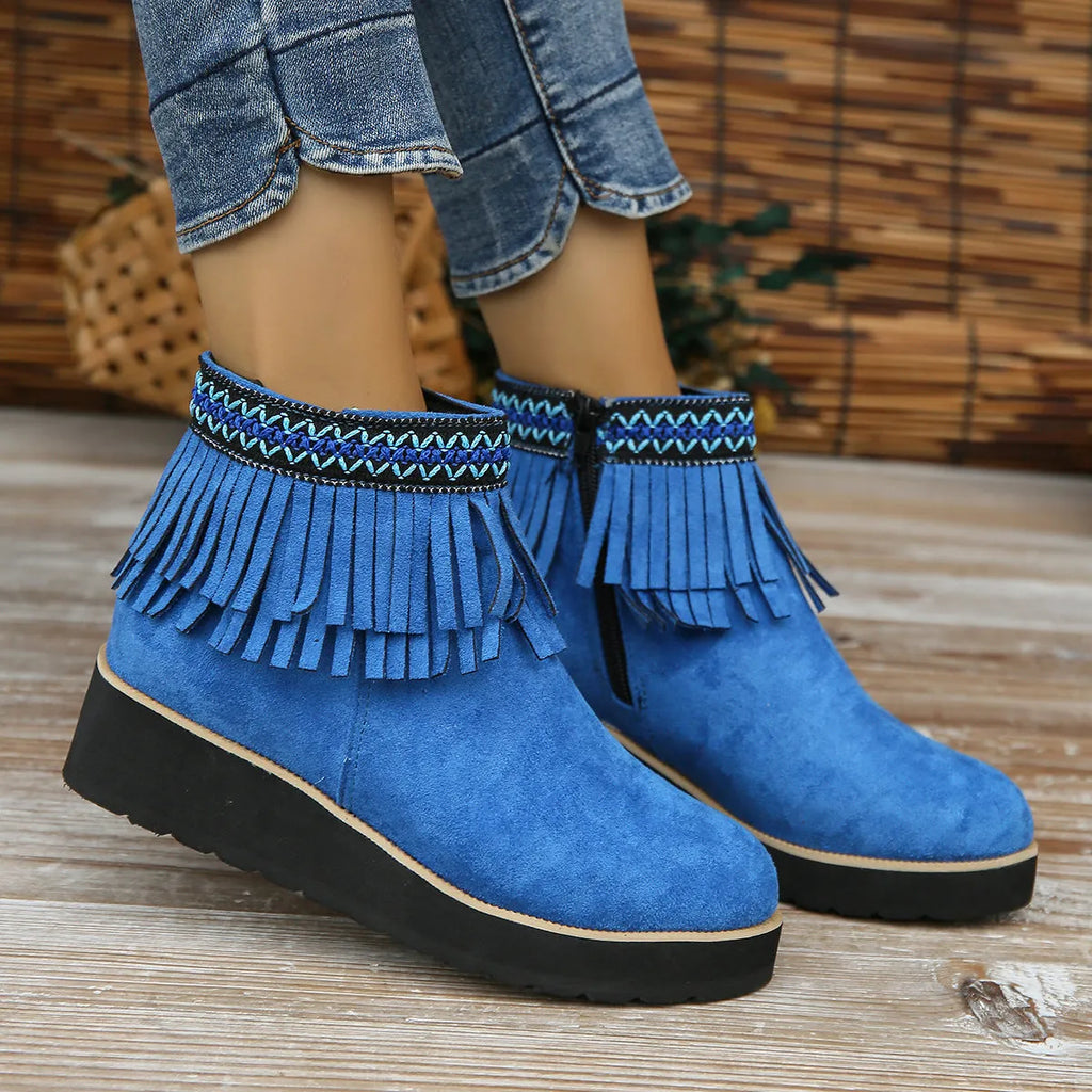 Women's dark brown suede ankle boots with wedge heel, platform sole, side zip, and tassel detail.