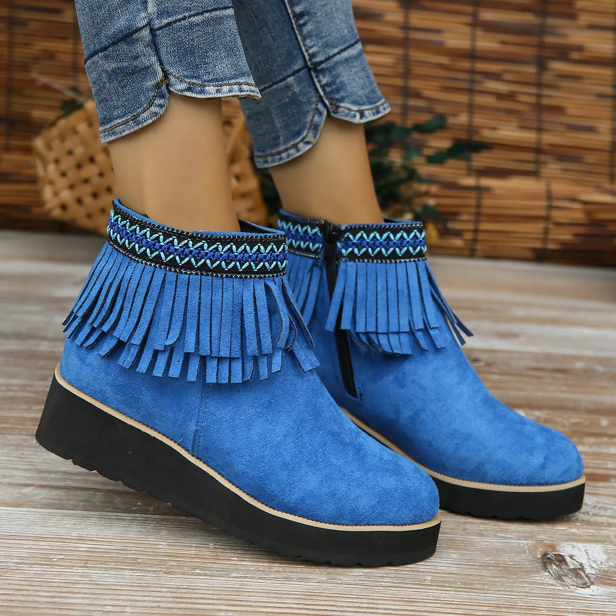 Women's dark brown suede ankle boots with wedge heel, platform sole, side zip, and tassel detail.