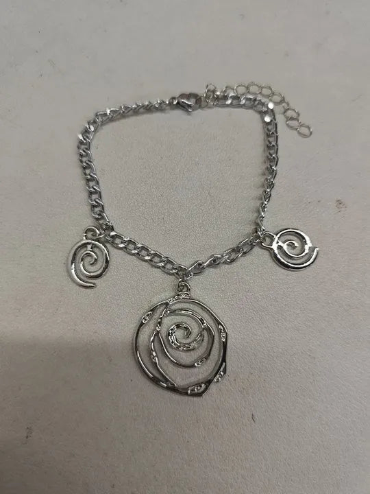 Gold spiral donut jewellery set showing necklace, bracelet and earrings with geometric circle design