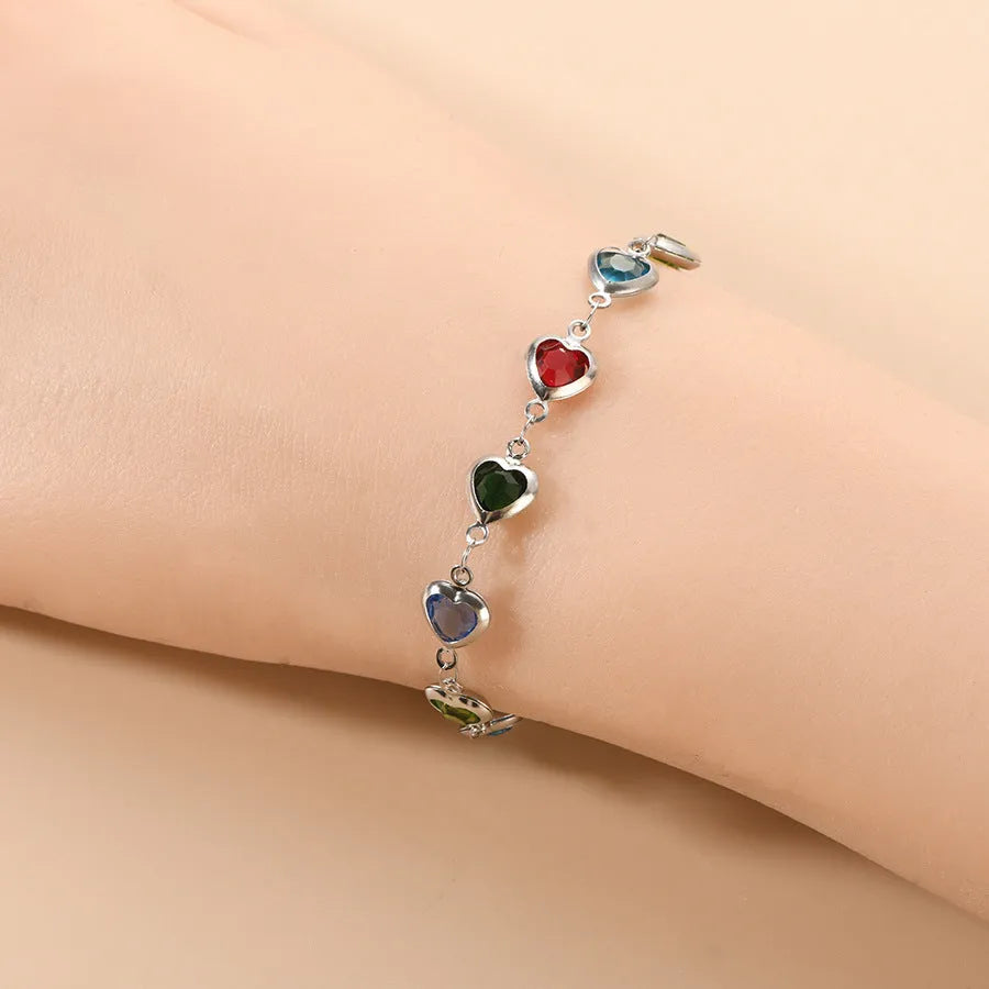 Stainless steel Devil's Eye geometric heart bracelet in red, blue, or green on a white background.