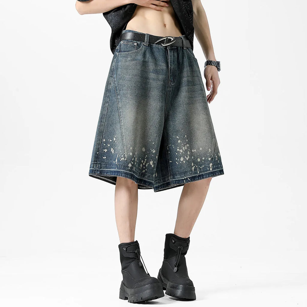 Men's retro blue denim shorts with ripped details, splash ink design, and five-point star decorations on a straight-leg cut.