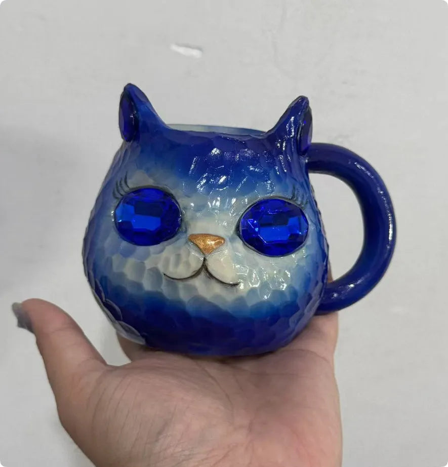 Colourful resin Crystal Earth Cat Cup craft decorative gift on a table.