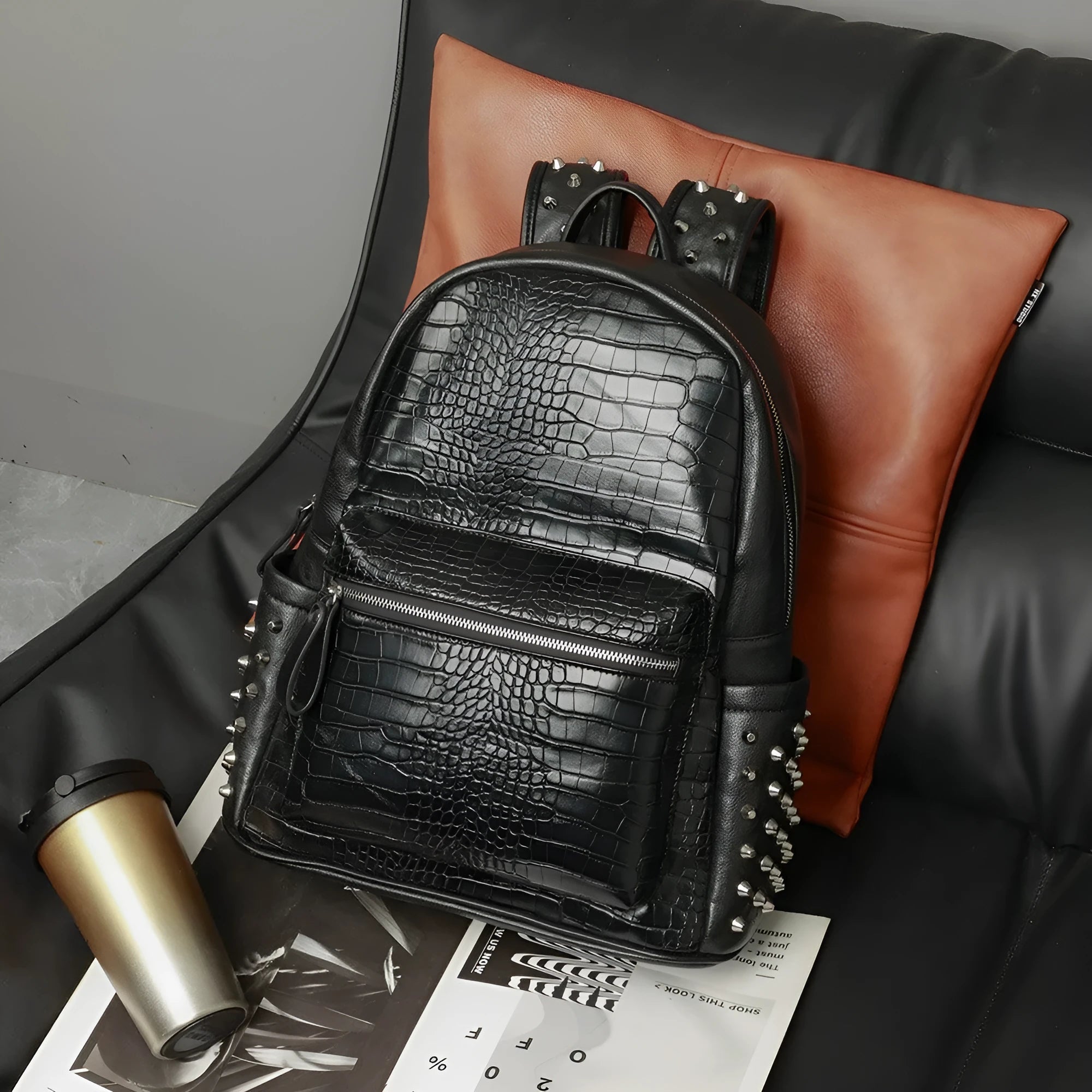Black PU leather computer schoolbag with rivet detailing showing 36-55L capacity