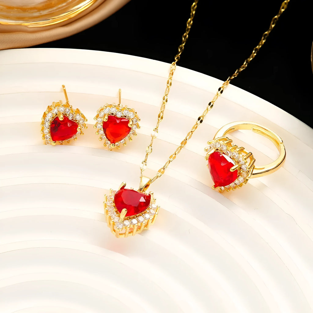 Gold-red titanium steel jewellery set for women with heart-shaped flower pendant, matching stud earrings, and ring.