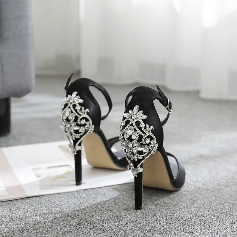 Black suede women's high heel shoes with rhinestone decoration and a fish mouth toe.