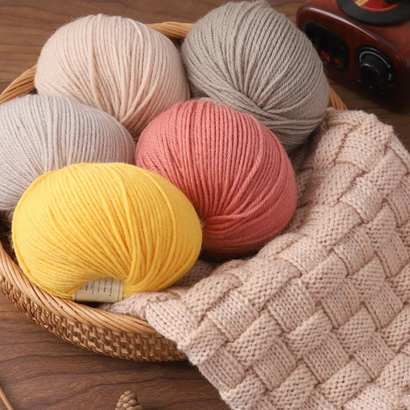 A roll of hand knitting wool thread in a choice of colours for baby sweater projects.
