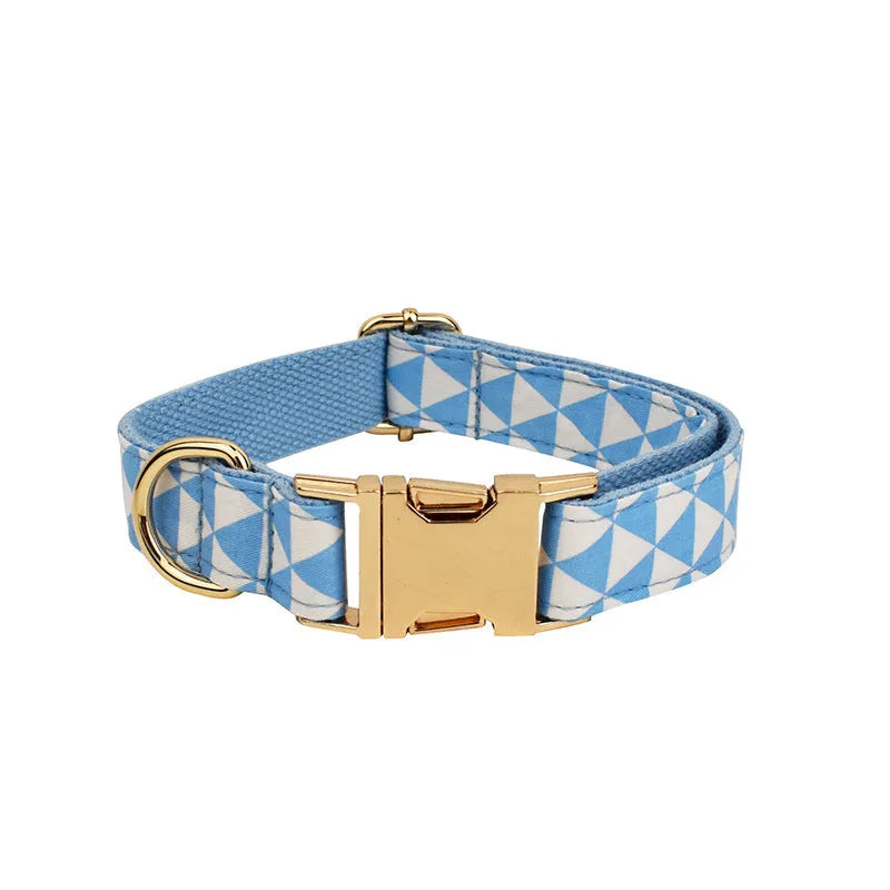 Blue cloth dog vest harness set with matching collar, leash, and decorative bow tie on a small dog
