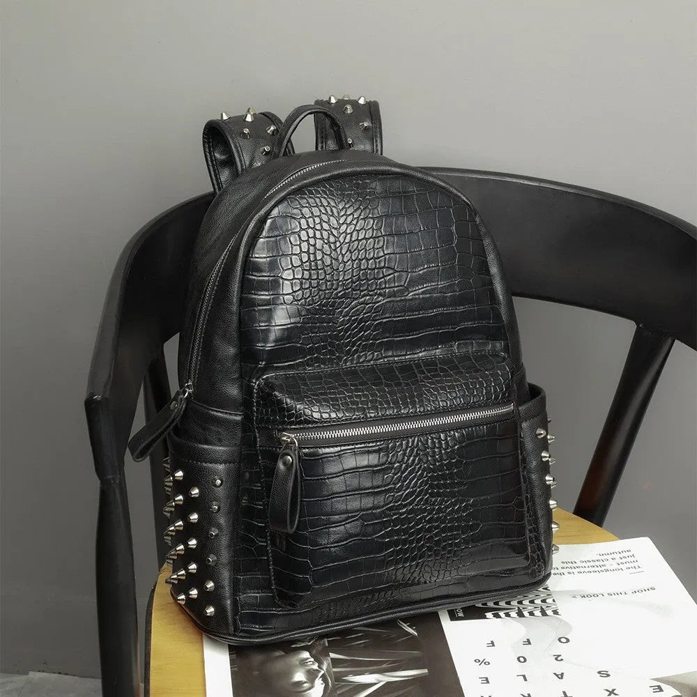 Black PU leather computer schoolbag with rivet detailing showing 36-55L capacity