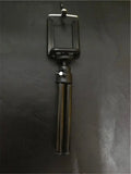 Black and silver desktop phone holder with an adjustable two-section bracket on a wooden desk.