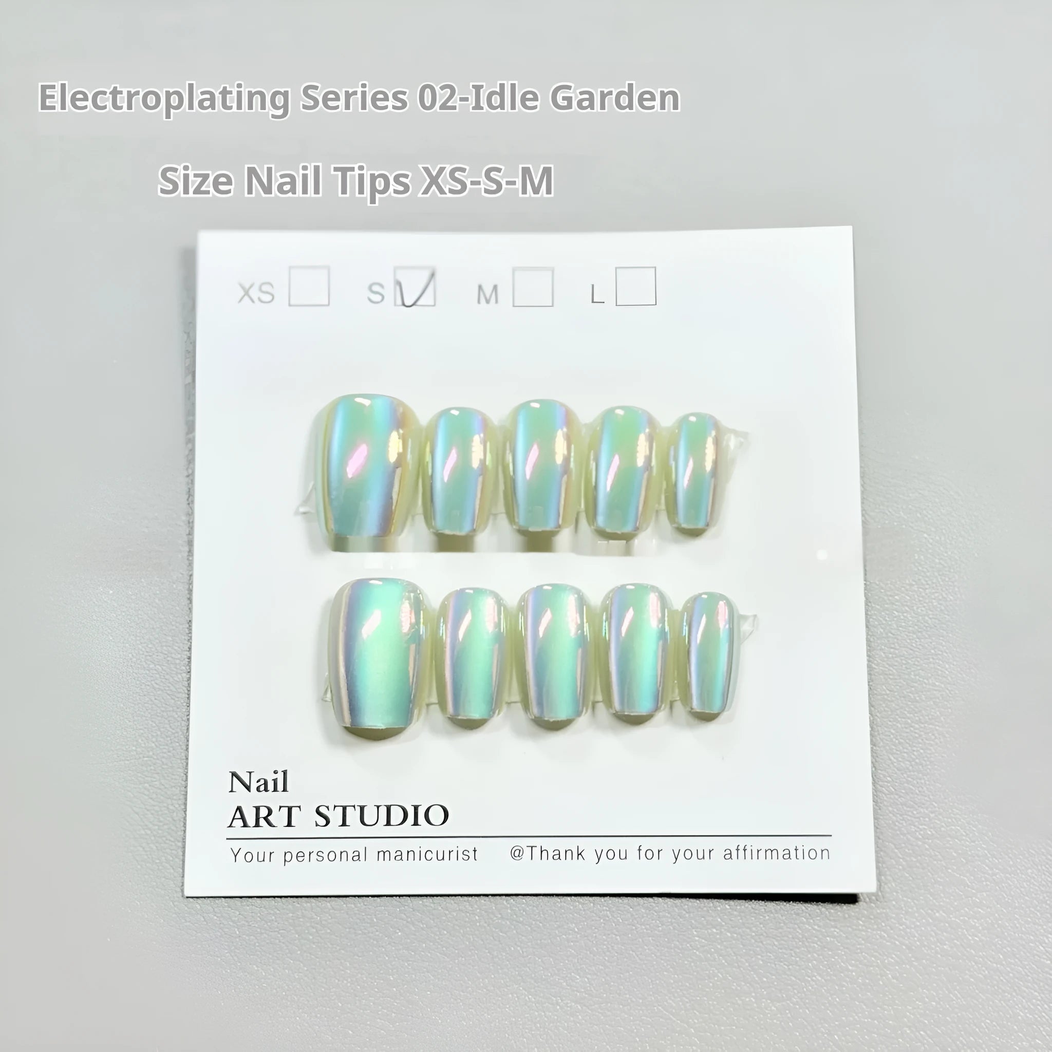 Set of electroplated Cat's Eye false nails with Aurora armour style in short ladder almond shape.