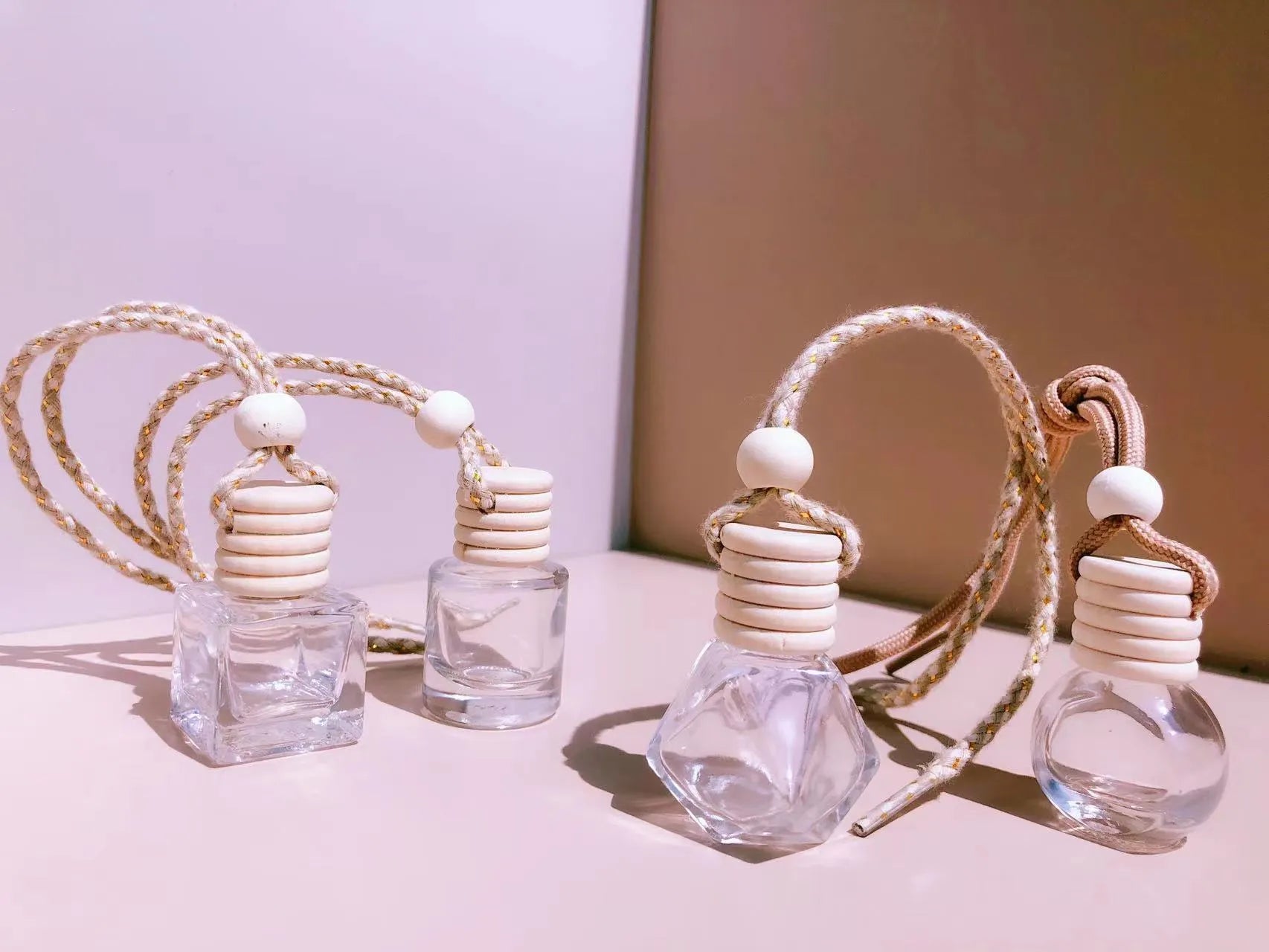 Glass car perfume pendant air freshener in cylinder, diamond, flat drum, and square shapes.