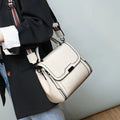 Women's brown genuine leather messenger bag with shoulder strap and internal pockets