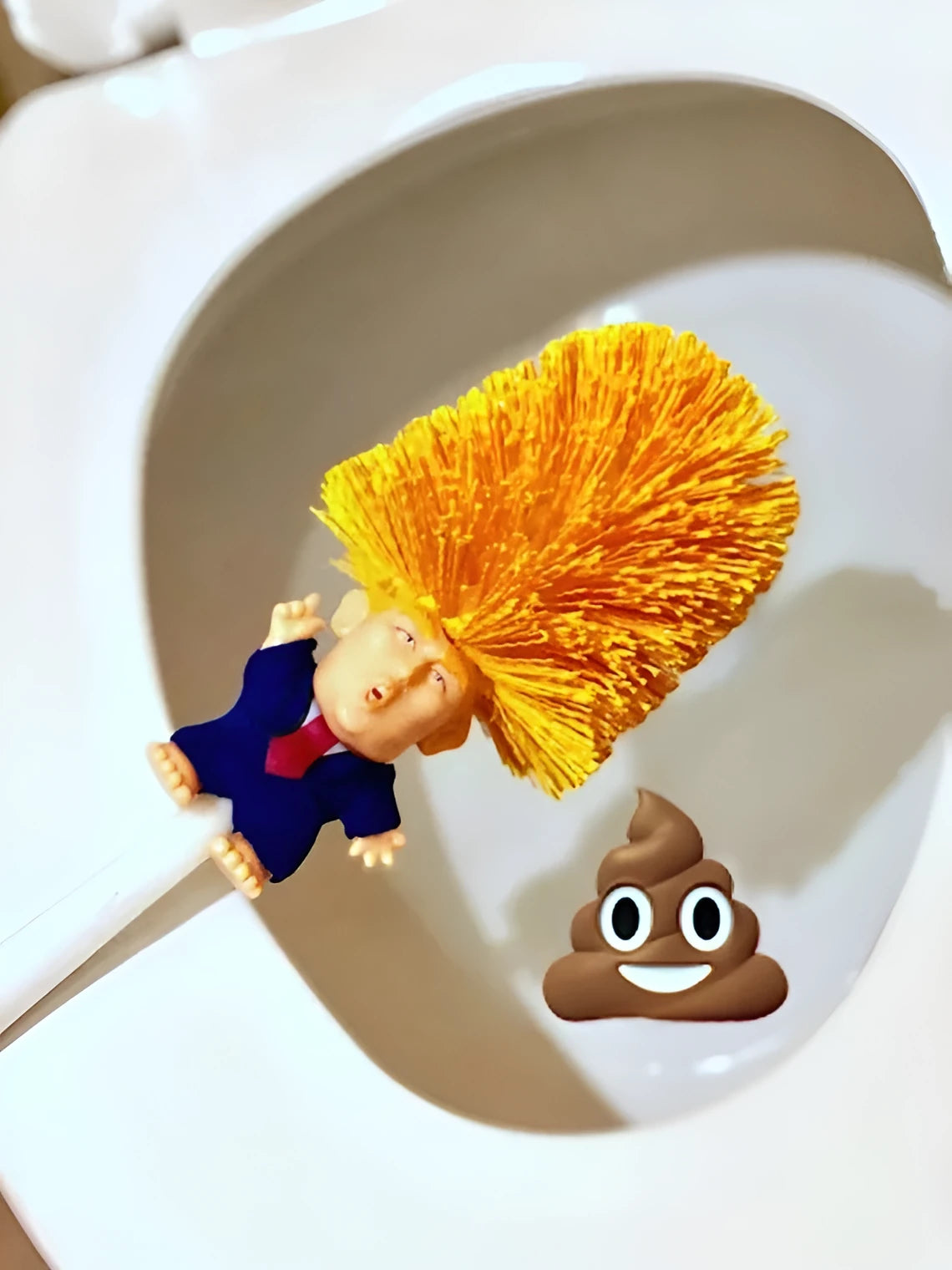 Yellow plastic Donald Trump novelty toilet brush with hanging slot.