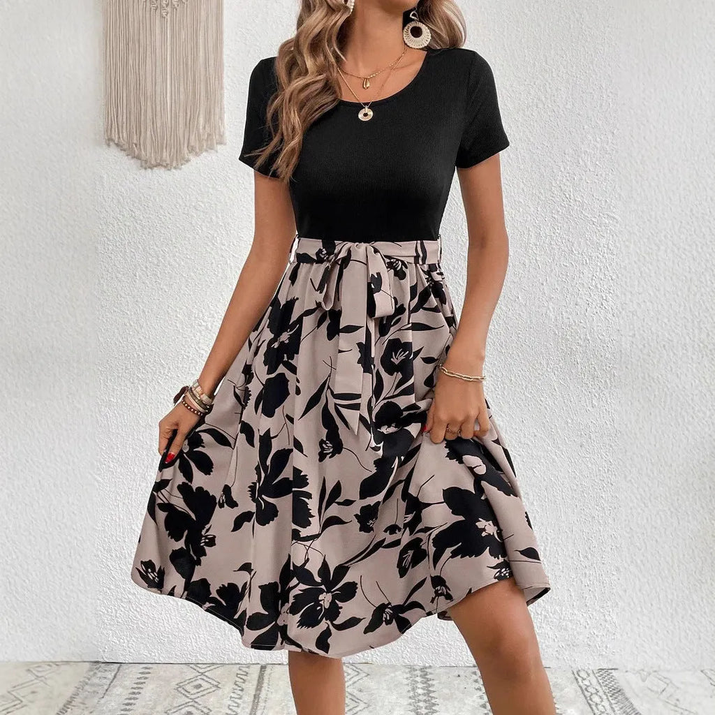 Khaki women's A-line dress with floral print and lace-up shoulder straps on a hanger.