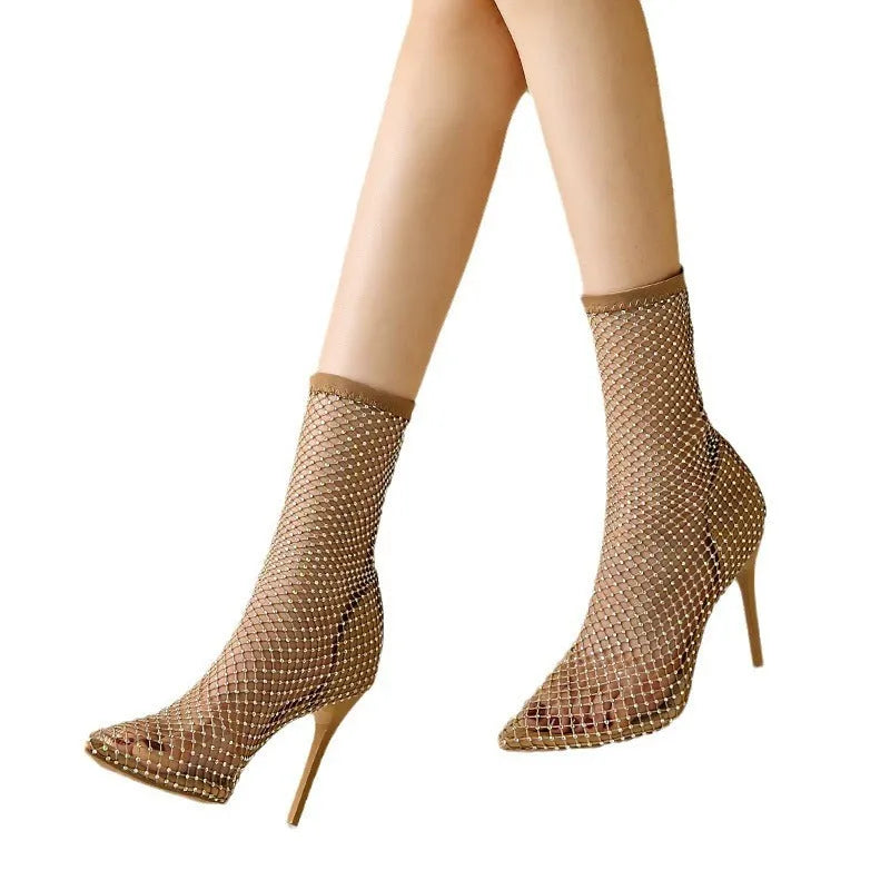 Gold high heel sandals with mesh upper and pointed stiletto design on rubber sole