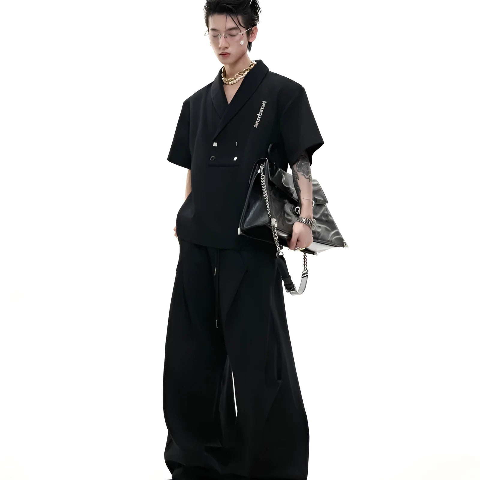 Man wearing a dark grey V-neck padded shoulder short sleeve jacket and matching shorts, a cotton sports suit set.