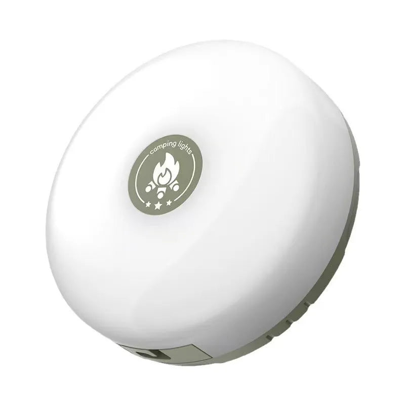 Charging multifunctional camping lantern with warm and colourful light modes on a campsite table