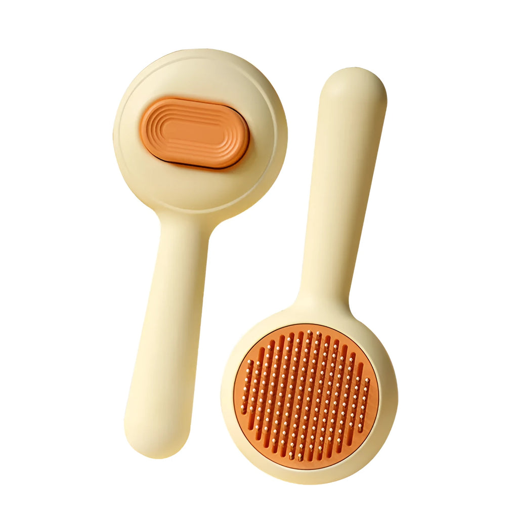 Green cat grooming brush with stainless steel teeth and a removable hair collection tray on a white background.