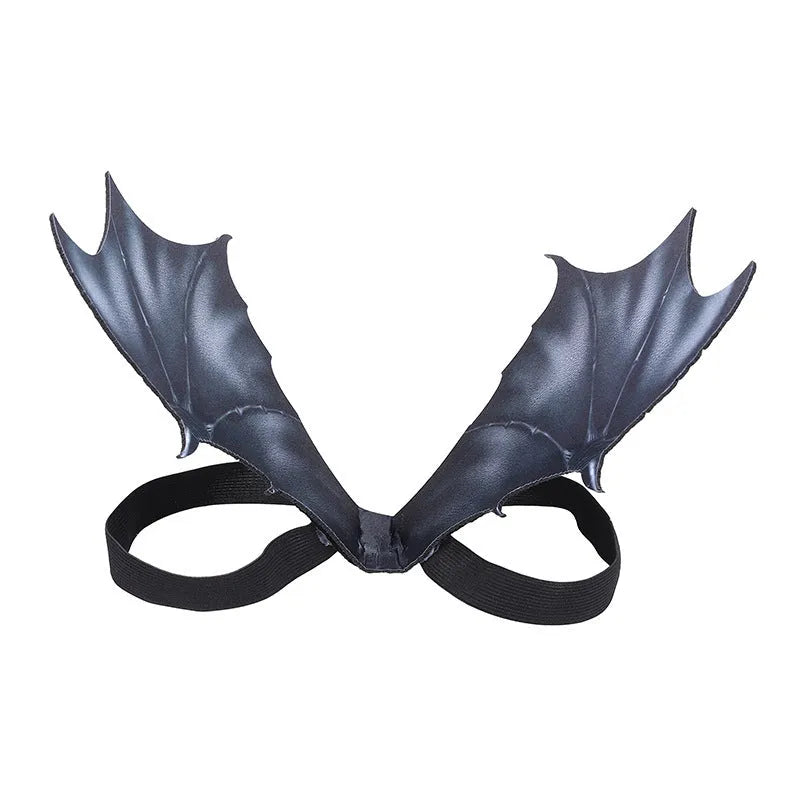 Black cloth bat wing costume accessory for a dog or cat on a Halloween background.