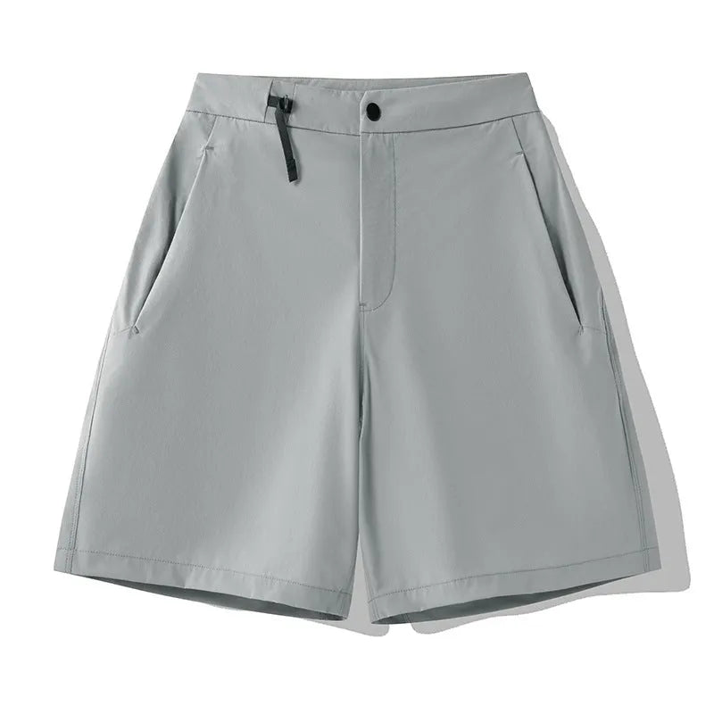 Men's quick-drying sports shorts in khaki colour with 3D cut and elastic waistband on a plain background.