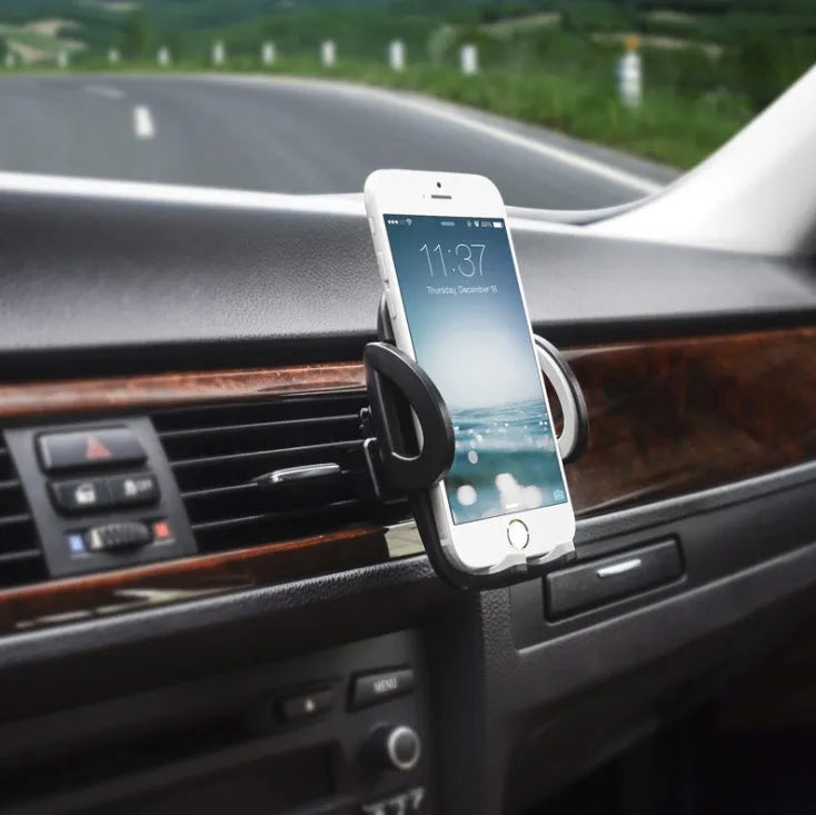 Black car phone holder clipped to air conditioning vent with smartphone secured in adjustable bracket