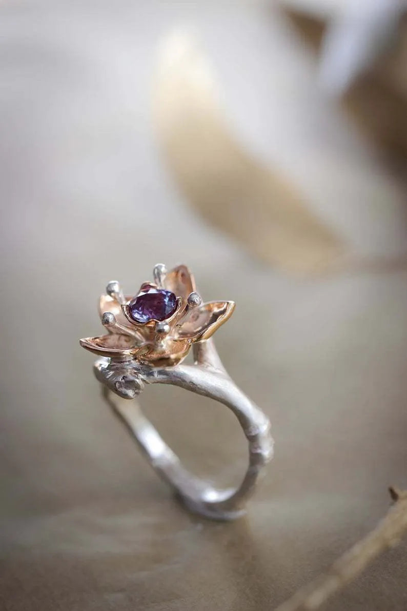 Silver two-tone floral geometric women's alloy ring on a plain background.