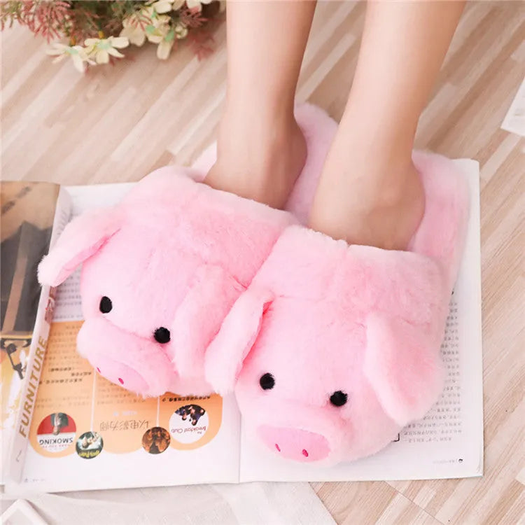 Pink pig-shaped plush floor slippers with short plush exterior.