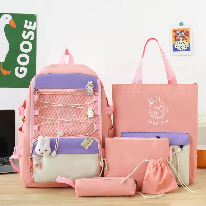 Solid colour nylon school backpack with curved shoulder straps, shown in black, blue, pink, and purple options.