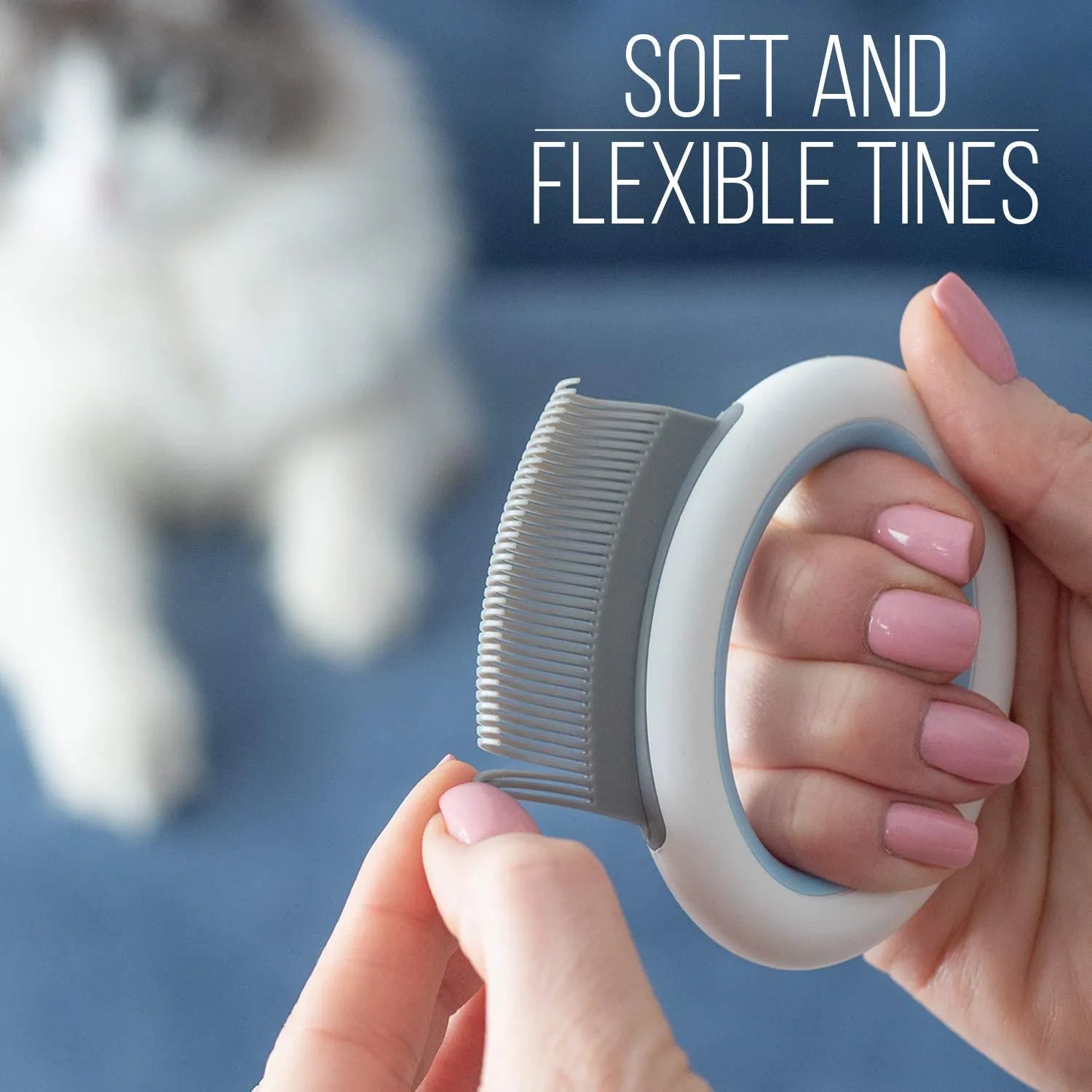 Blue pet grooming comb with soft teeth and an ergonomic plastic handle on a white background.