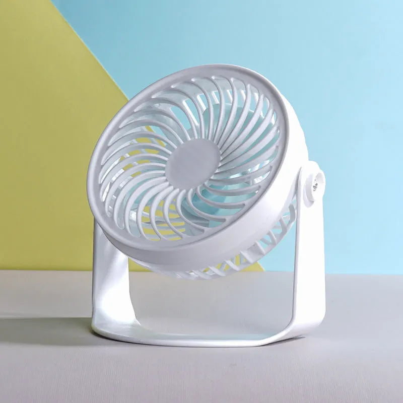 Compact USB desk fan shown in both clip-on and mini floor standing styles on a wooden desk.