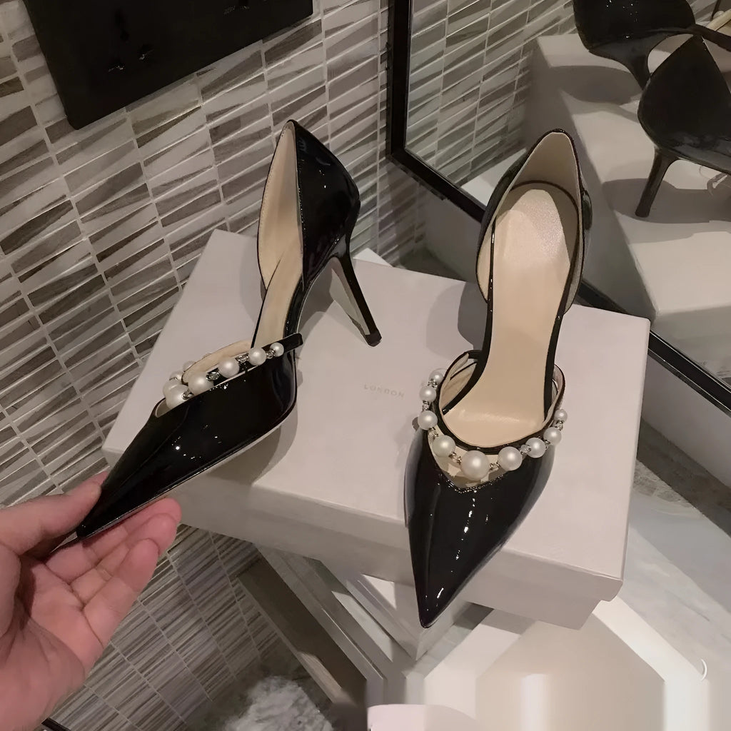 Women's patent leather pointed toe high heels with pearl accents on stiletto heel