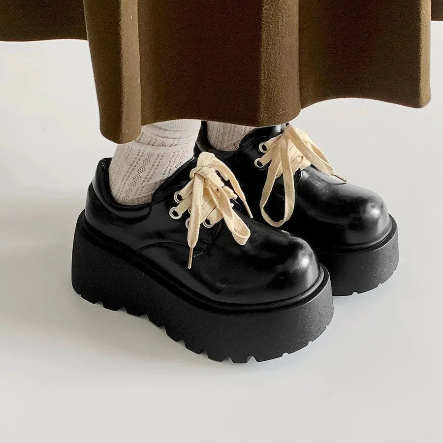 Matte black women's lace-up boots with thick rubber sole and English muffin heel