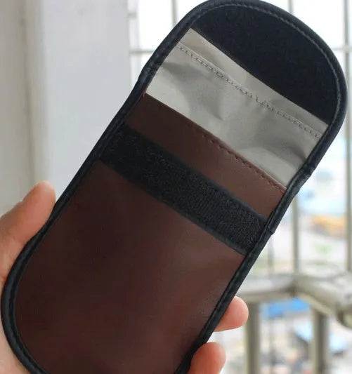 Black microfiber RFID signal blocker bag measuring 13.5 by 9.5 centimetres.