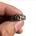 Hand-forged copper ring with a grotto Buddha design and textured rock finish, shown in size 8.