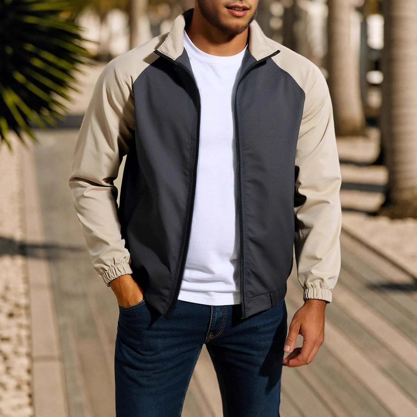 Man wearing a green stand collar casual jacket with raglan sleeves.