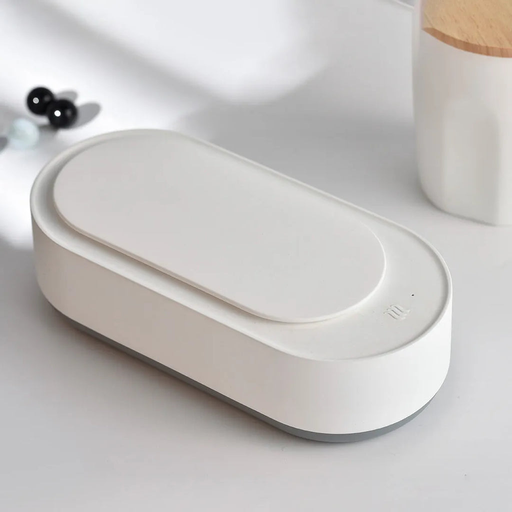 White portable ultrasonic cleaner with stainless steel tank and touch button.