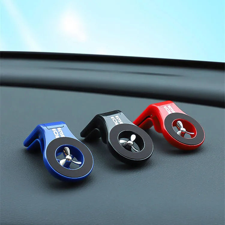 Black magnetic car air vent phone holder with adjustable ball joint and fragrance disc attached.