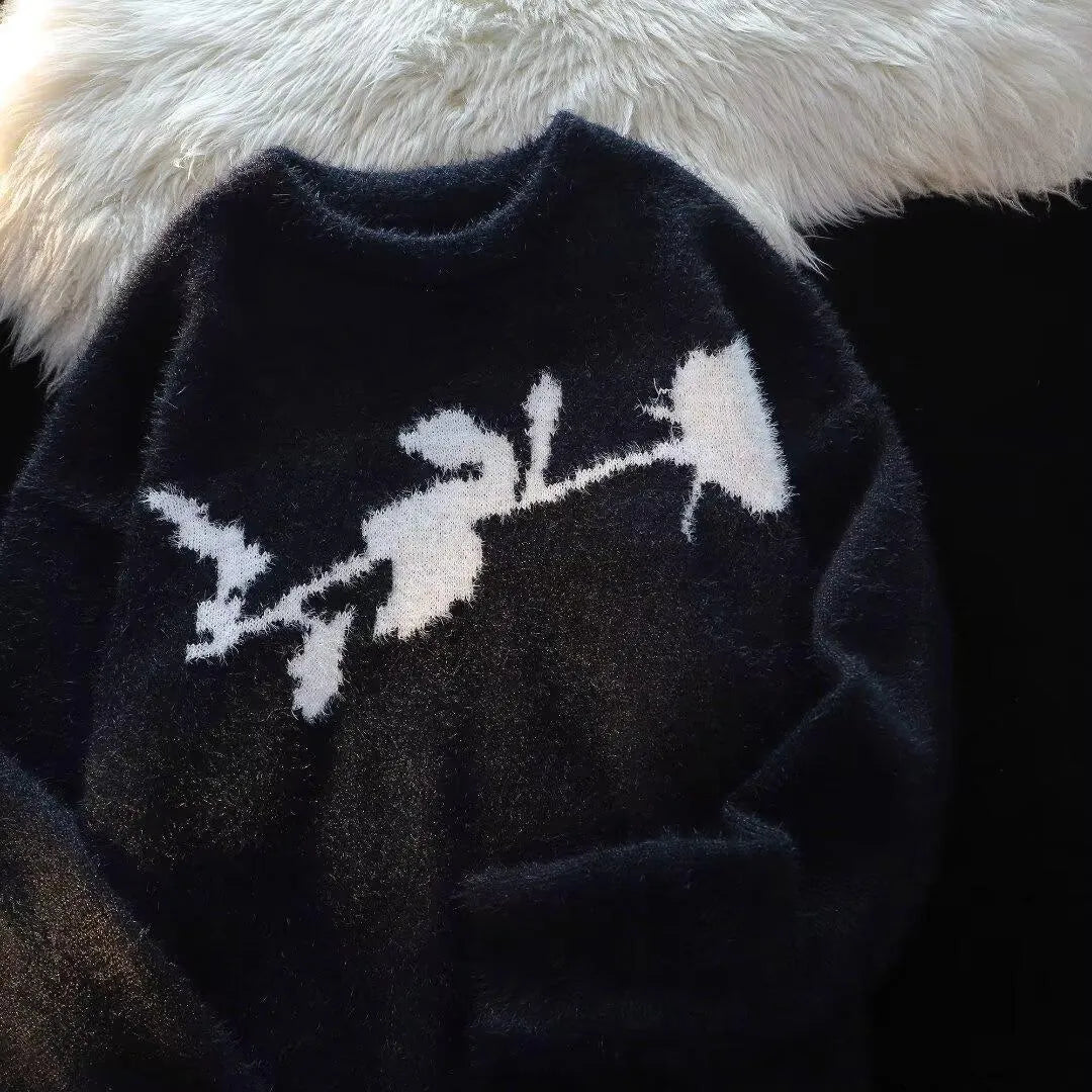 Man wearing a black cotton fleece sweater with a flocking horse and American Dark Rose pattern.