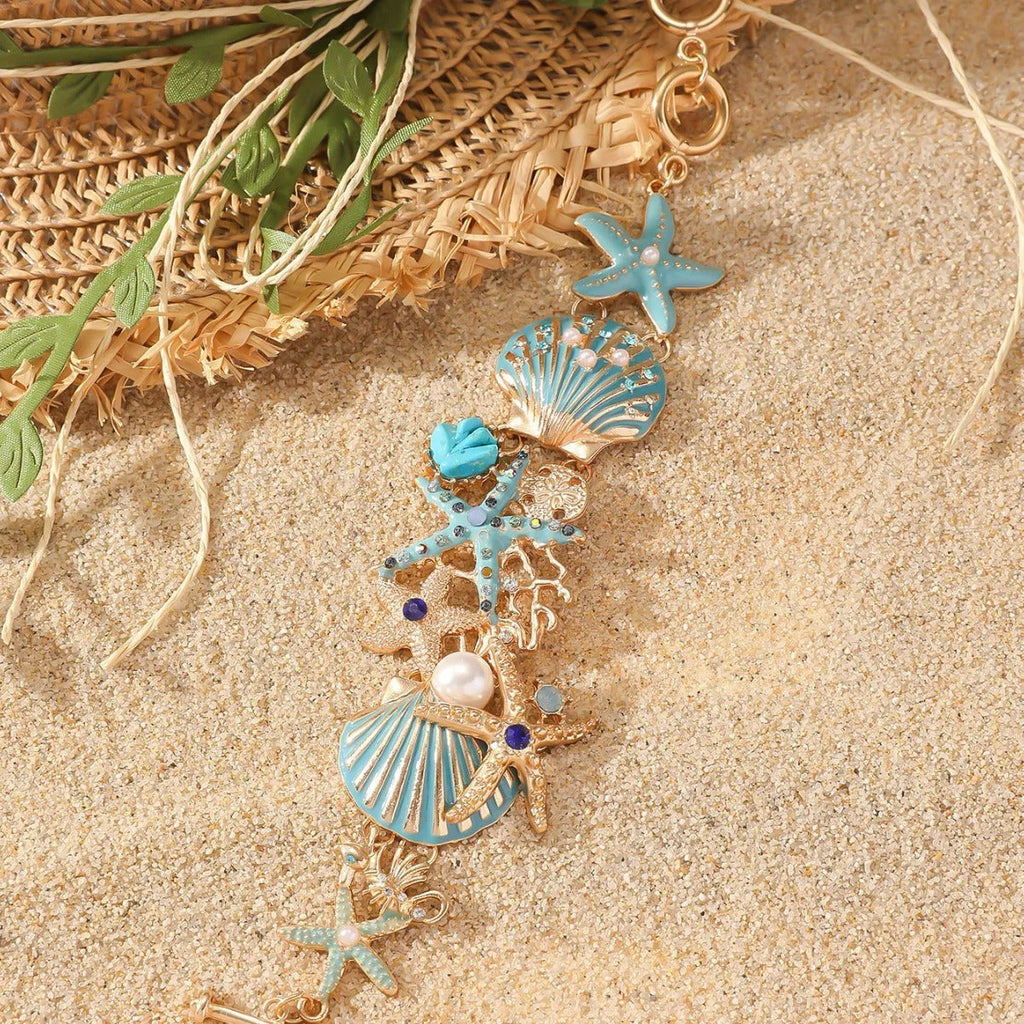 Women's alloy marine bracelet with starfish and anchor detailing in turquoise, red or blue coral colour.