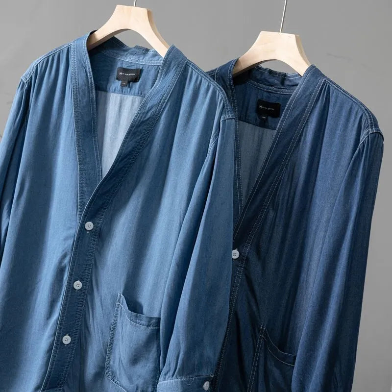 Men's dark blue denim coat with three-quarter sleeves and V-neck collar showing front pocket detail