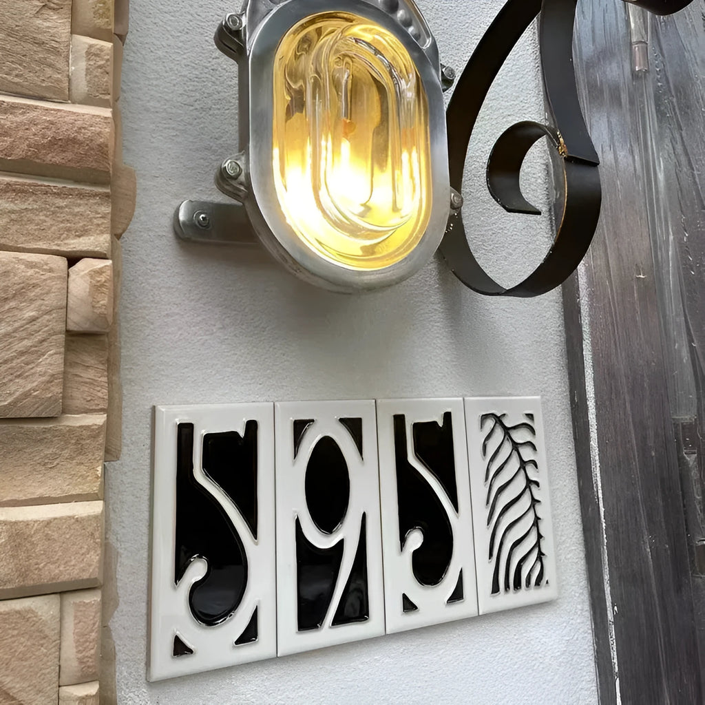 Handmade retro-style ceramic doorplate with white enamel number on a blue glazed background.