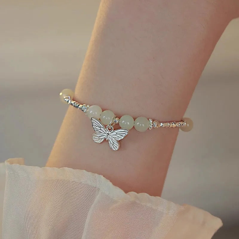 Silver butterfly jewellery set with hetian jade accents showing bracelet and necklace combination