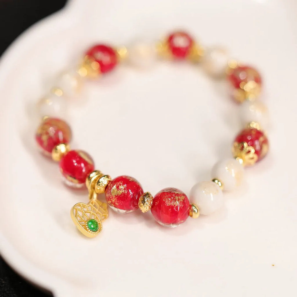 Close-up of a manually crafted gold foil coloured glaze ethnic bracelet for women, showing geometric design.