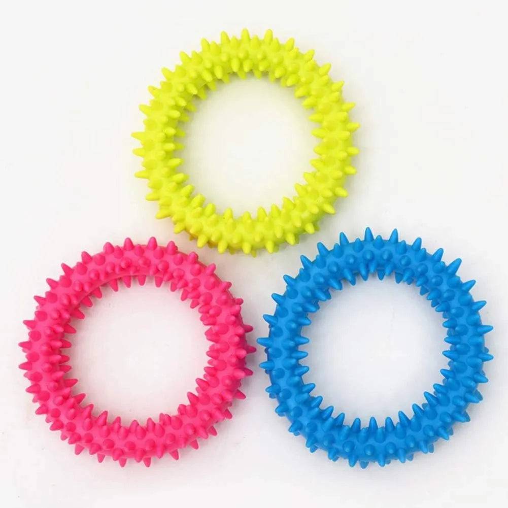 Blue TPR spiked ring dog chew toy for dental cleaning and bite training on a white background.