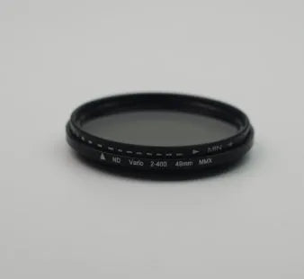 Set of neutral density camera lens filters in ND2, ND4, ND8, and ND400 with various thread sizes from 37mm to 95mm.