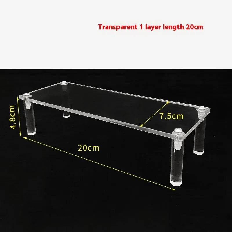 Transparent acrylic ladder display rack with three trapezoidal tiers showing blind box figurines on a desk
