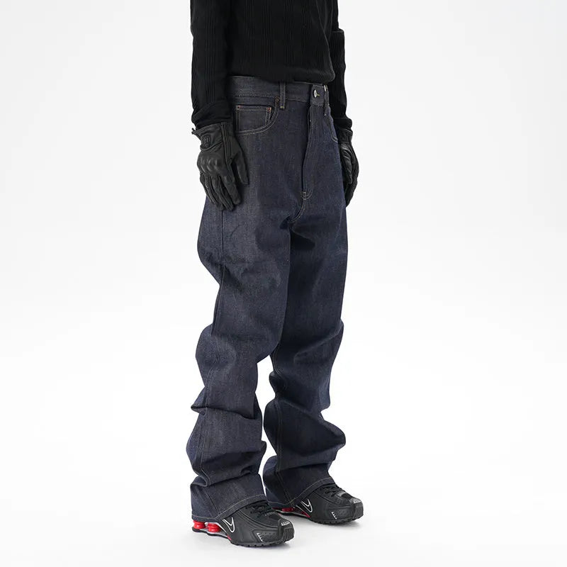 Man wearing dark blue loose straight-leg casual jeans.