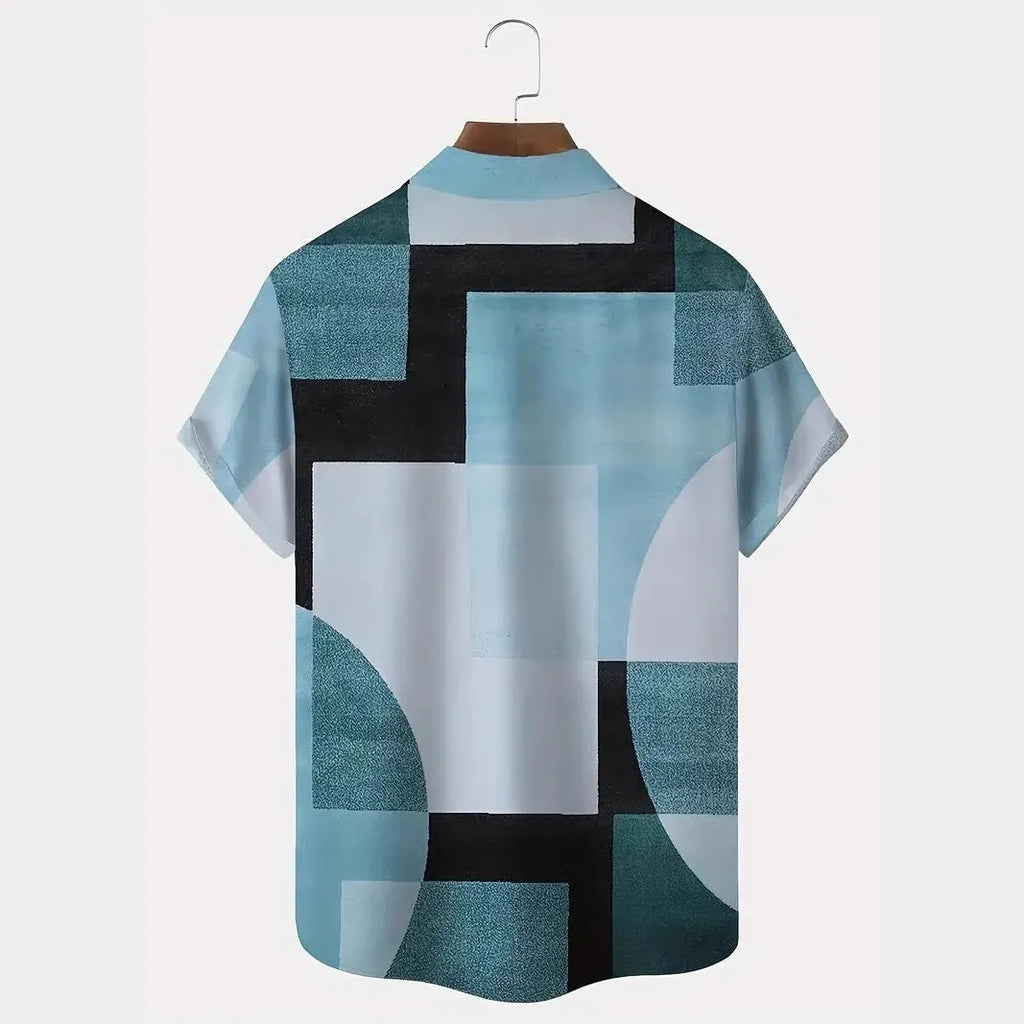 Man wearing a loose-fit cardigan shirt with a retro geometric square print in contrasting colours.