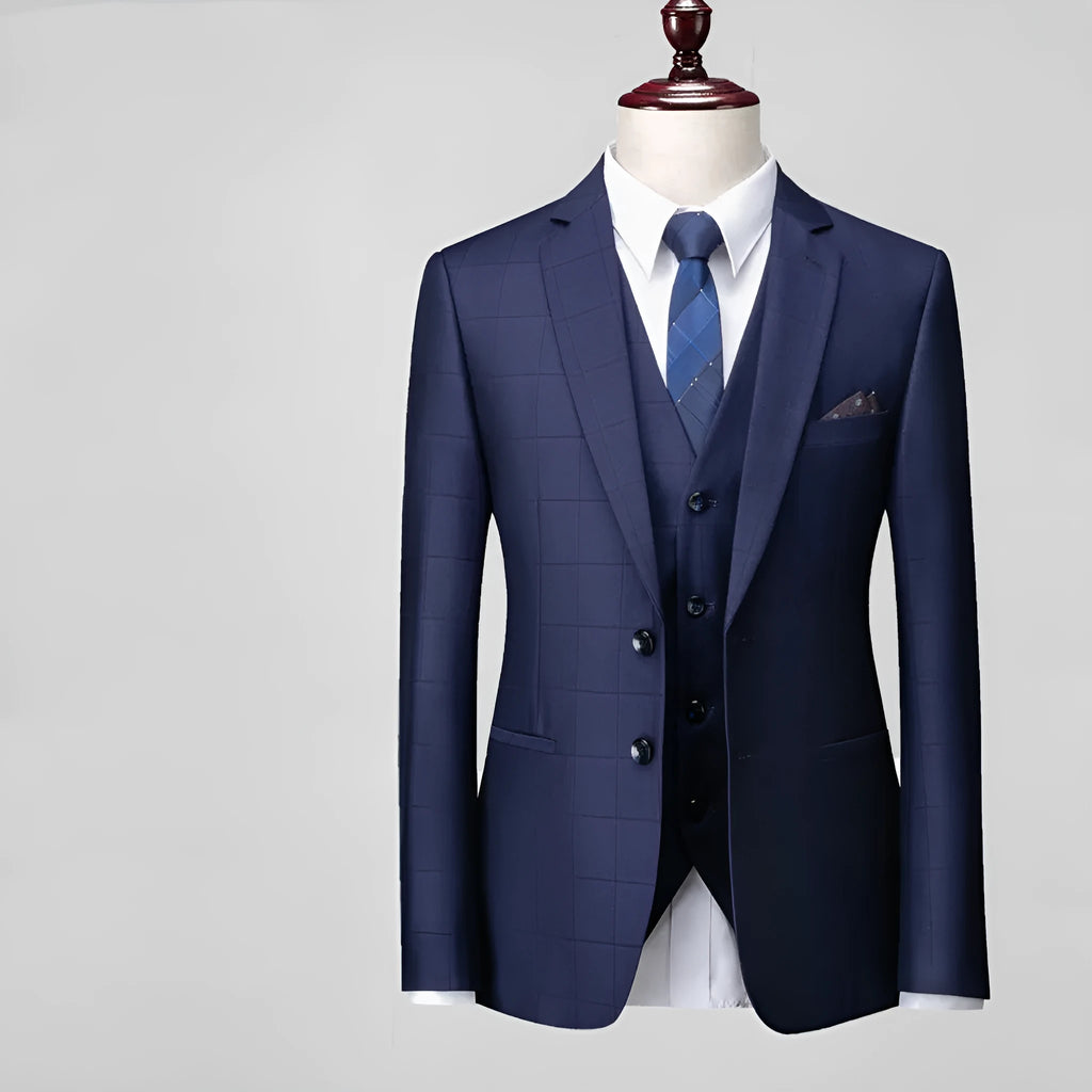 Men's navy blue plaid slim fit three-piece suit with jacket, vest, and trousers on hanger